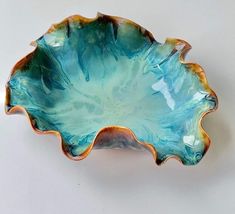 a blue and brown bowl sitting on top of a table