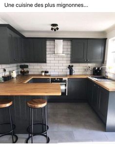 an image of a kitchen setting with grey cabinets and wood counter tops in the middle