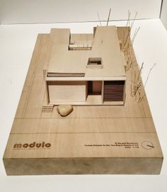 a wooden model of a house on display