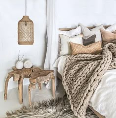 a bedroom with white walls and fur rugs on the floor next to a bed