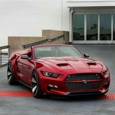 a red sports car parked in front of a building