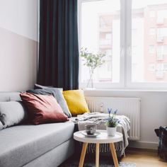 a living room filled with furniture and a large window