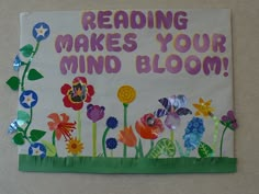 a sign that reads reading makes your mind bloom with flowers and butterflies in the grass