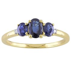 three stone ring in yellow gold with blue sapphires and white topazte stones