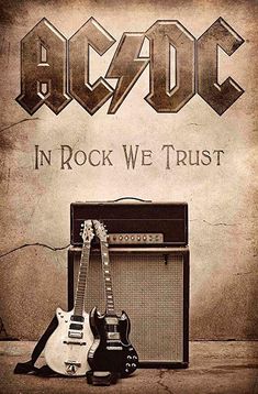 an electric guitar and amp sitting next to each other in front of a wall with the words ac / dc in rock we trust