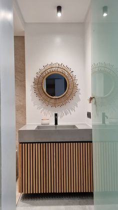 a bathroom with a sink and mirror in it