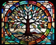 a stained glass window with a tree in it