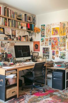 a home office with lots of bookshelves and pictures on the wall above it