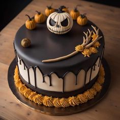 a decorated halloween cake with pumpkins and antlers on the top is sitting on a wooden table