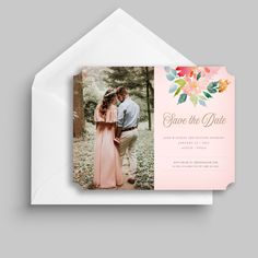 the save the date card is shown with an image of a couple in pink and orange flowers