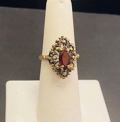 Beautiful 10k Gold ladies antique Gold garnet gemstone ring Size 6.5(Re-Sizing is available if needed) Please see my shop with hundreds of other incredible pieces of unique jewelry! We are a 100 year old, 5th generation, family business called Colonial Coin & Jewelers in Cleveland Ohio.  Satisfaction guaranteed or return for full refund. Vintage Garnet Birthstone Ring In Yellow Gold, Vintage Yellow Gold Garnet Birthstone Ring, Vintage Gold Garnet Birthstone Ring, Ornate Gold Ruby Ring, Vintage Oval Garnet Birthstone Ring, Ornate 14k Gold Ruby Ring For Anniversary, Vintage Garnet Birthstone Ring For Anniversary, Ornate Gold Ring With Ruby, Ornate Gold Rings With Ruby