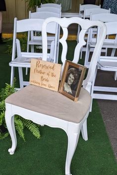 a white chair with a sign that says reserved wedding the bride