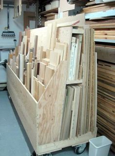 a large wooden cart filled with lots of different types of wood planks and plywood boards