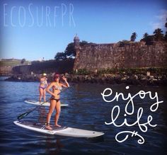 two women are paddle boarding in the water