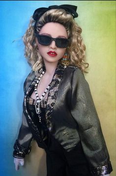 a close up of a doll wearing sunglasses