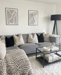 a living room filled with furniture and pillows on top of a white carpeted floor