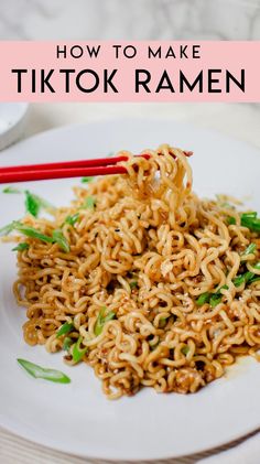 a white plate topped with noodles and chopsticks