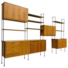 three wooden shelves and two metal shelving units