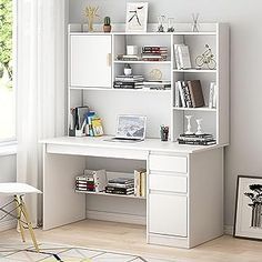 a white desk and chair in front of a window with bookshelves on it