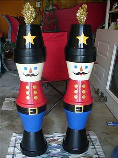 two wooden nutcrackers with gold stars on their heads, one is red and the other is blue