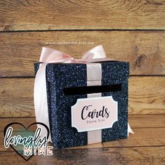 a black and white gift box with a pink bow on it that says cards thank you