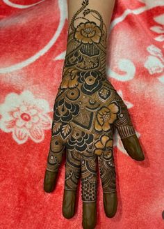 the hand is decorated with henna and flowers