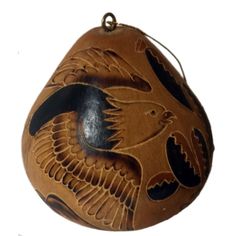 an ornament with a bird painted on it's side and black accents