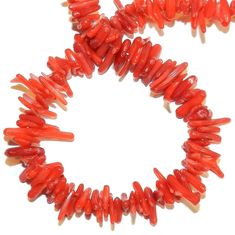 red coral beads are arranged in a circle