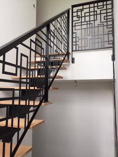 a black and white stair case next to a wall