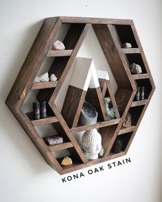 a wooden shelf filled with different types of rocks and vases on top of it