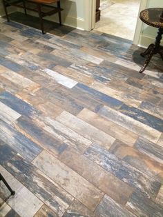 a wooden floor with blue and white tiles on it