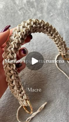 a woman holding onto a bracelet made out of rope