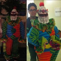 two men standing next to each other with clowns on their heads and in costumes