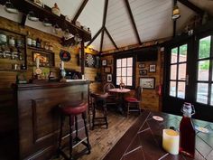 the inside of a restaurant with wood paneling and leather bar stools next to a counter