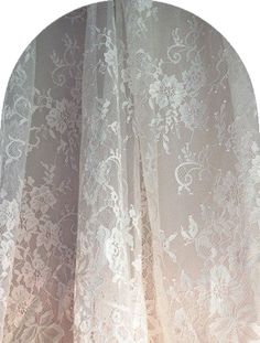 an image of a white lace curtain with floral design on it's edges and bottom