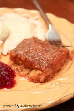 a close up of a plate of food with ice cream and fruit on the side