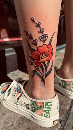 a woman's foot with a flower tattoo on it