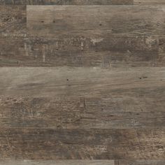 wood flooring that looks like it has been made from old planks and is brown