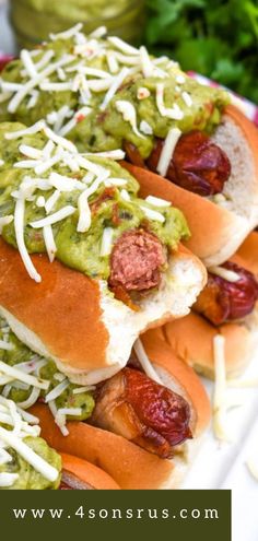 three hotdogs with guacamole and relish on them are sitting on a plate