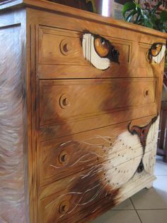 a painting of a cat's face on a dresser