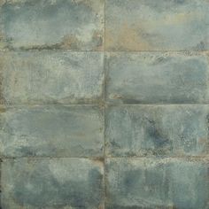 an image of a grungy wall textured with concrete blocks in blue and grey