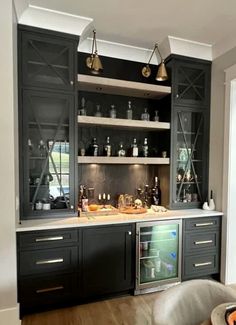 a kitchen with black cabinets and white counter tops