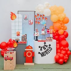 an assortment of balloons and decorations for a fireman's birthday party on a table