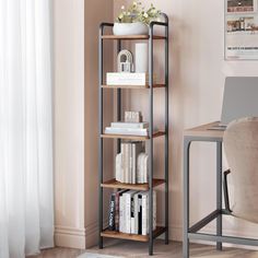 a room with a chair, desk and bookshelf next to a window in it