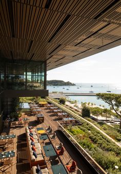 an outdoor restaurant with tables and chairs overlooking the ocean