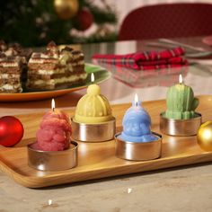 small candles are sitting on a tray with other desserts in the backround