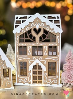 a gingerbread house with trees and lights in the background