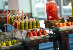 there are many different types of drinks on the table and in bottles next to each other