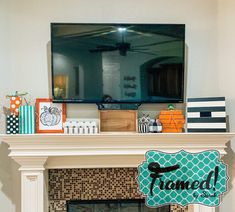 a fireplace mantel with a tv above it and some decorations on the mantles