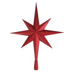 a red glittered star ornament hanging from a white wall with no background